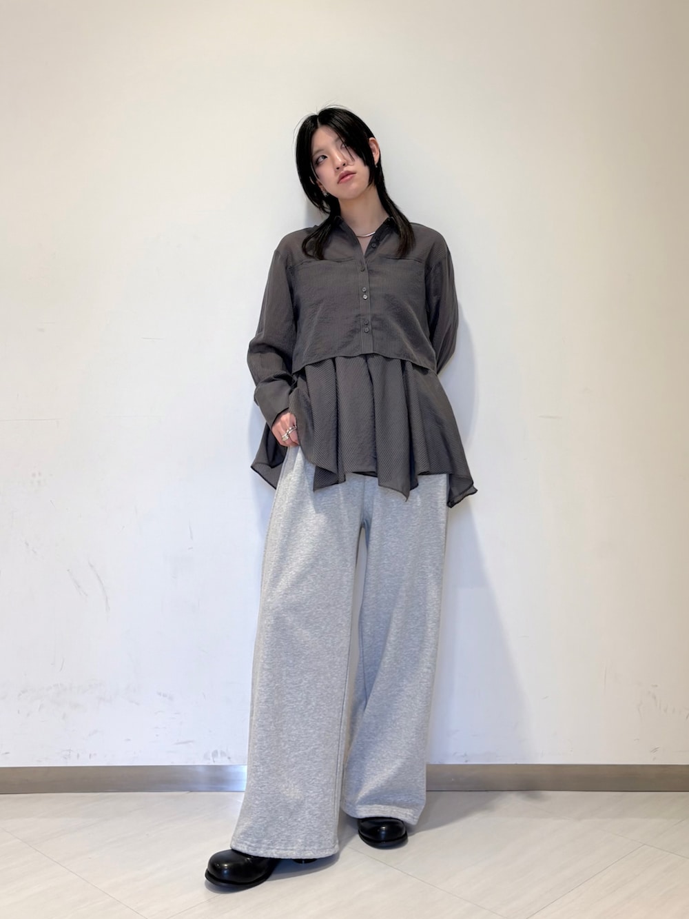 グレー系のシャツ/ブラウス、グレー系のその他パンツ、ブラック系のブルゾンを着用したレディースの冬コーディネートの2枚目の写真