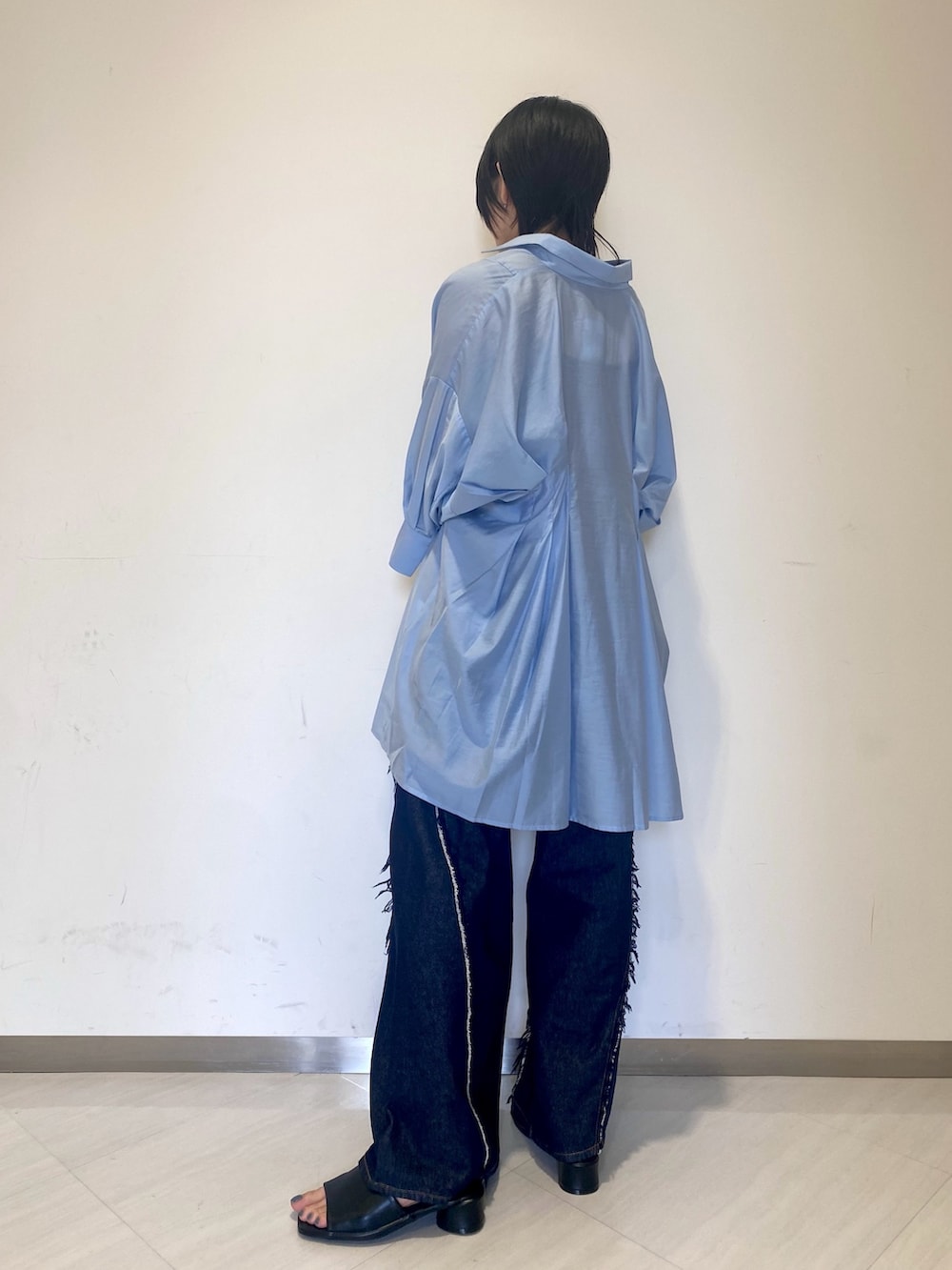 ブルー系のワンピース、シルバー系のショルダーバッグ、ブルー系のデニムパンツを着用したレディースの夏コーディネートの3枚目の写真