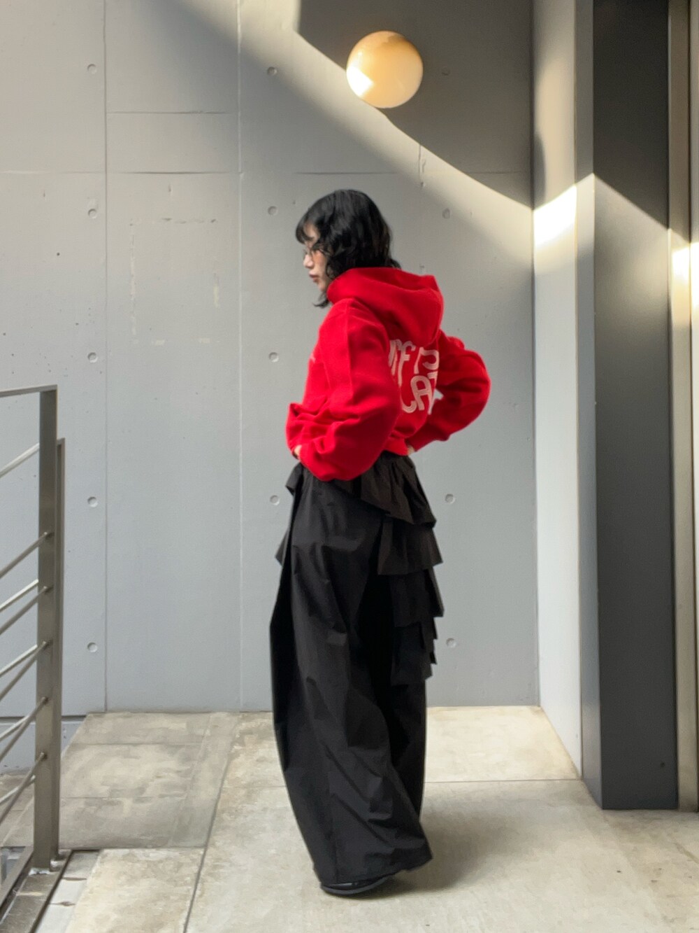 レッド系のニット/セーターを着用したレディースの冬コーディネートの3枚目の写真