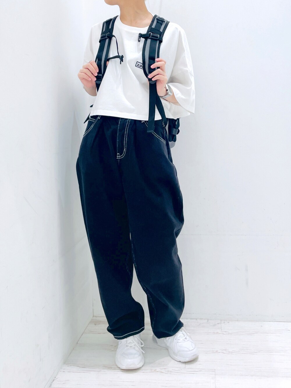 ブラック系のその他パンツ、ホワイト系のTシャツ/カットソー、グレー系のバックパック/リュックを着用したレディースの春コーディネートの4枚目の写真