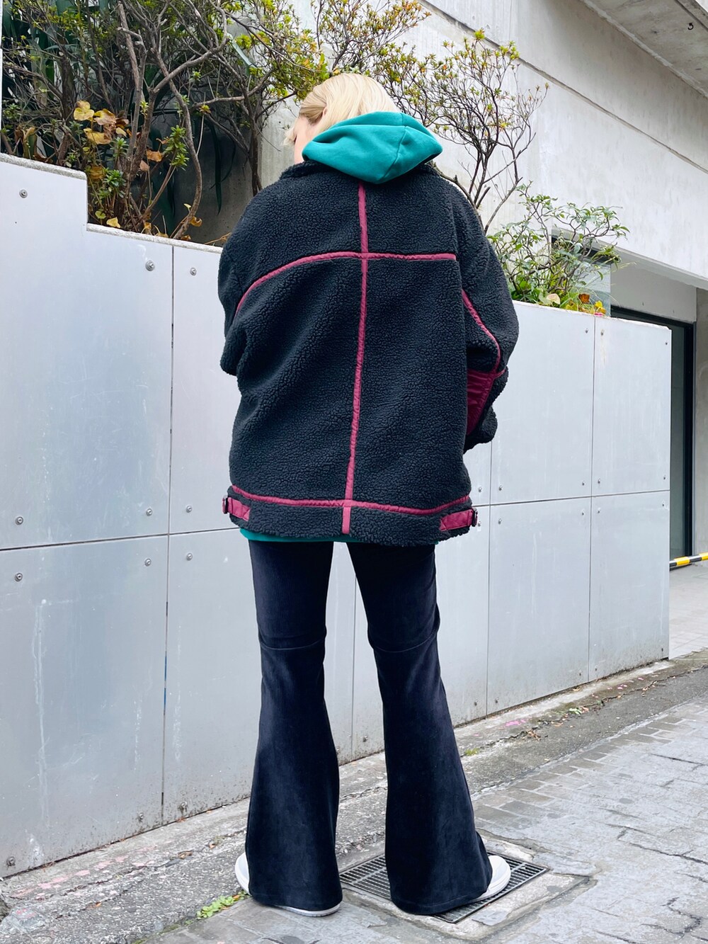 ブラック系のその他パンツ、ブラック系のブルゾン、グリーン系のパーカーを着用したレディースの冬コーディネートの2枚目の写真