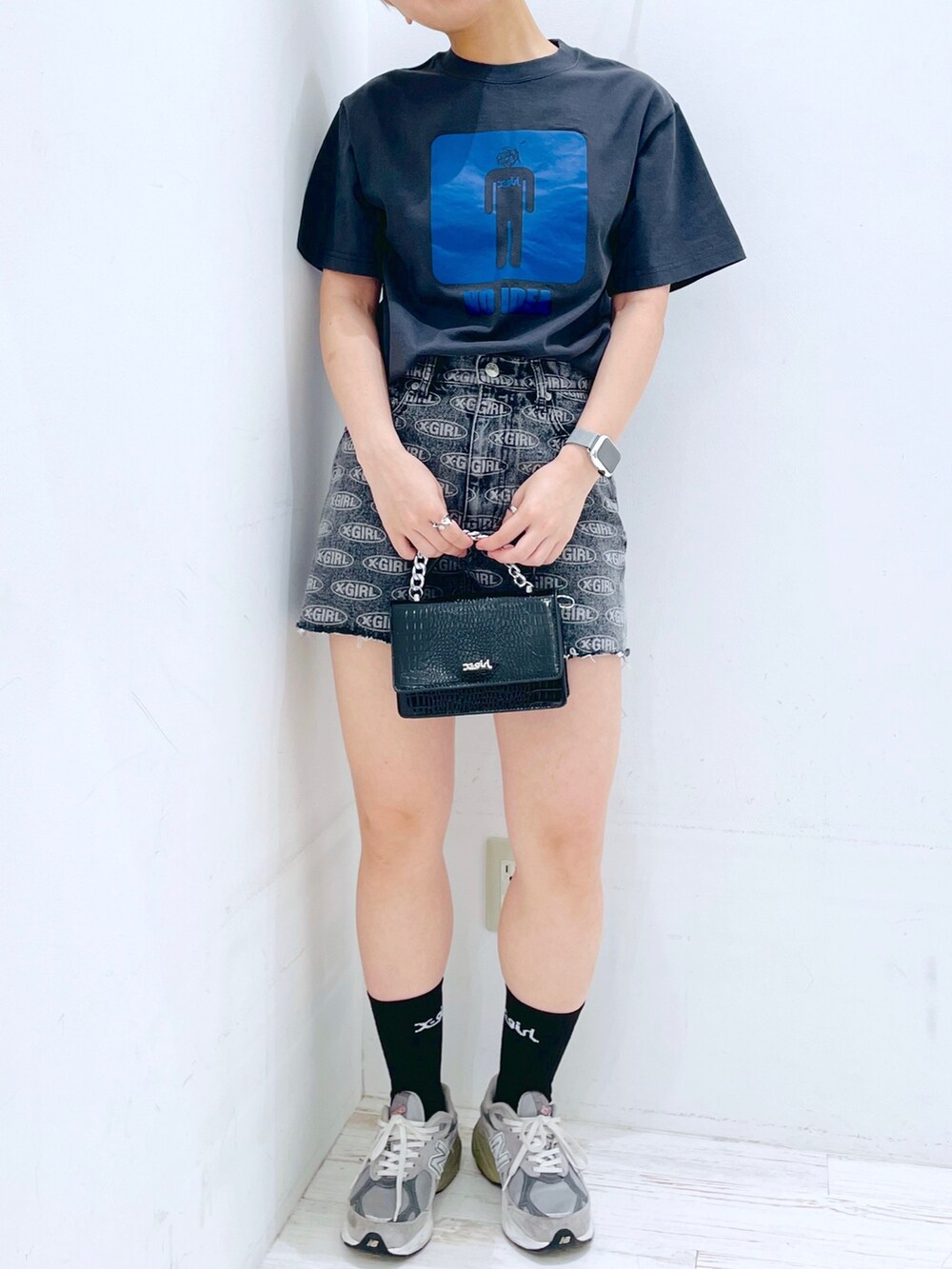 グレー系のTシャツ/カットソー、ブラック系のデニムパンツ、ブラック系のショルダーバッグを着用したレディースの春コーディネートの2枚目の写真