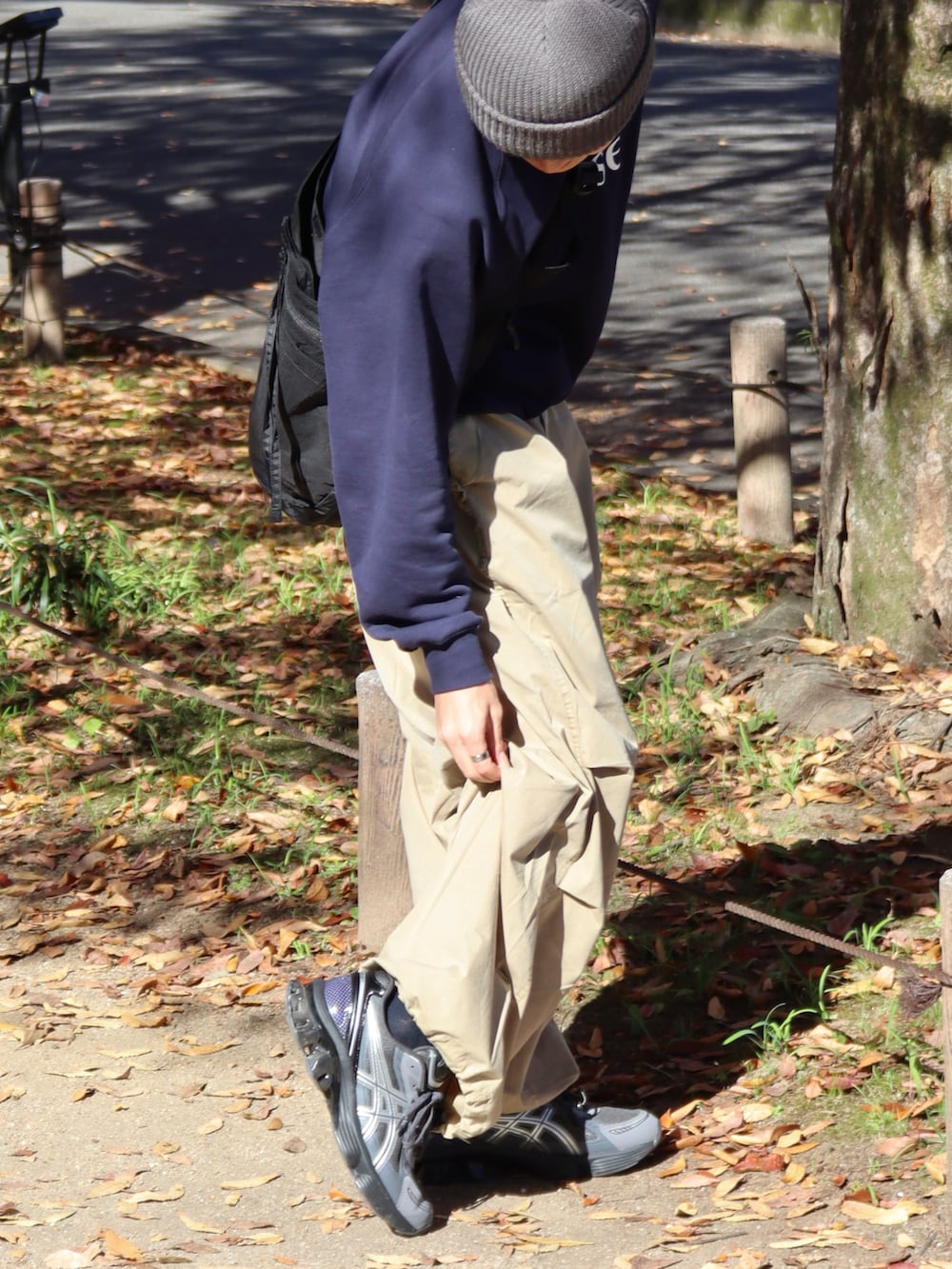 ベージュ系のカーゴパンツ、ブルー系のスウェット、ブラック系のショルダーバッグを着用したメンズの秋コーディネートの4枚目の写真