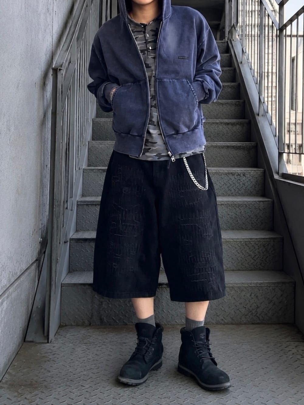 グレー系のTシャツ/カットソー、ブルー系のパーカー、ブラック系のブーツを着用したメンズの春コーディネートの3枚目の写真