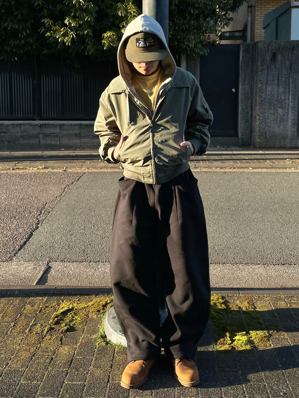 ブラック系のスウェットパンツ、イエロー系のTシャツ/カットソー、グリーン系のブルゾンを着用したメンズの春コーディネートの2枚目の写真