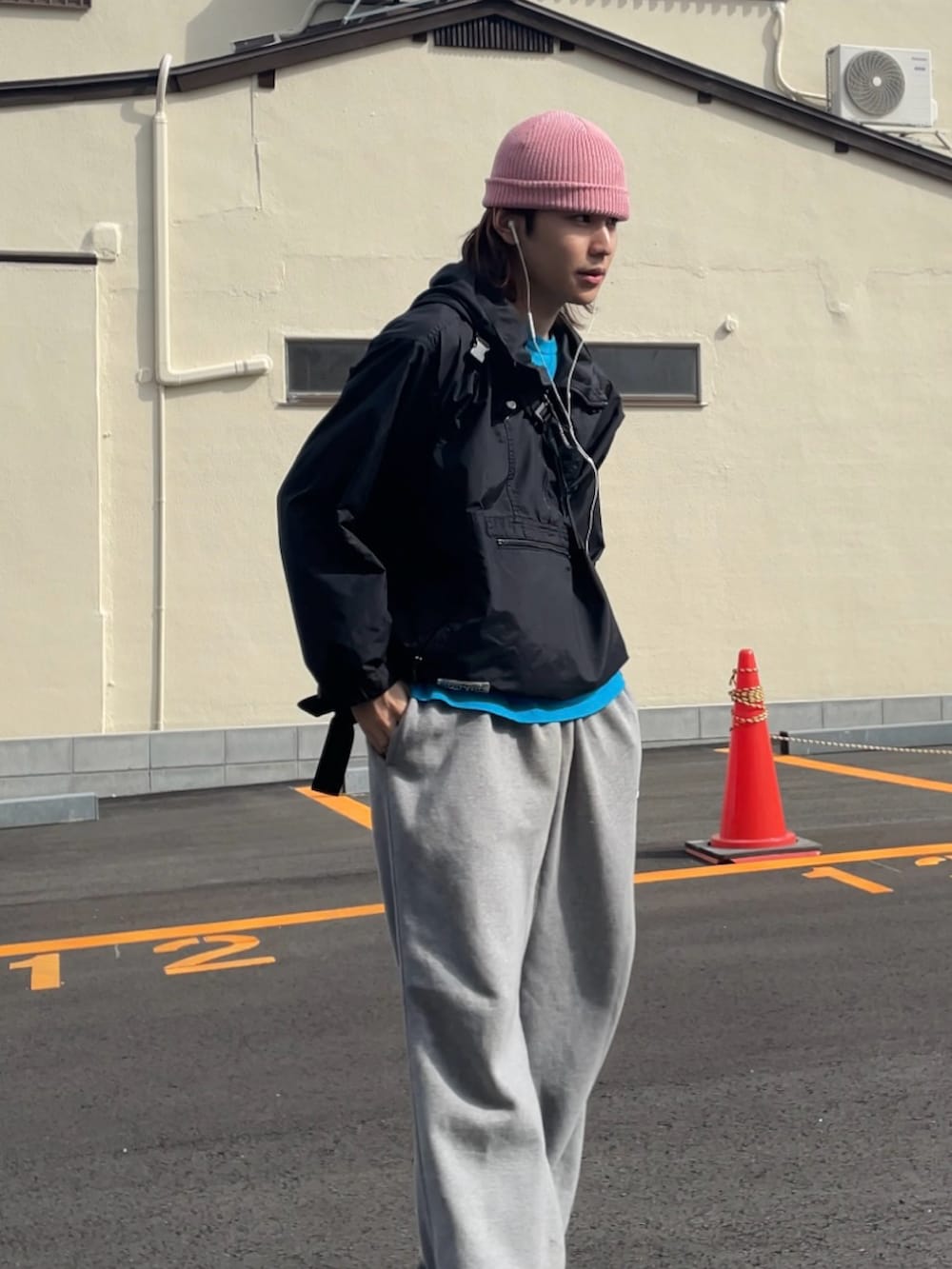 ブラック系のマウンテンパーカー、グレー系のスウェットパンツ、ブラック系のスニーカーを着用したメンズの春コーディネートの4枚目の写真