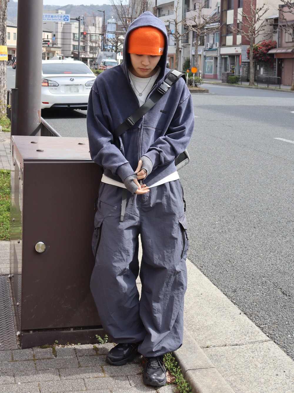 ブルー系のパーカー、ホワイト系のTシャツ/カットソー、グレー系のカーゴパンツを着用したメンズの春コーディネートの3枚目の写真