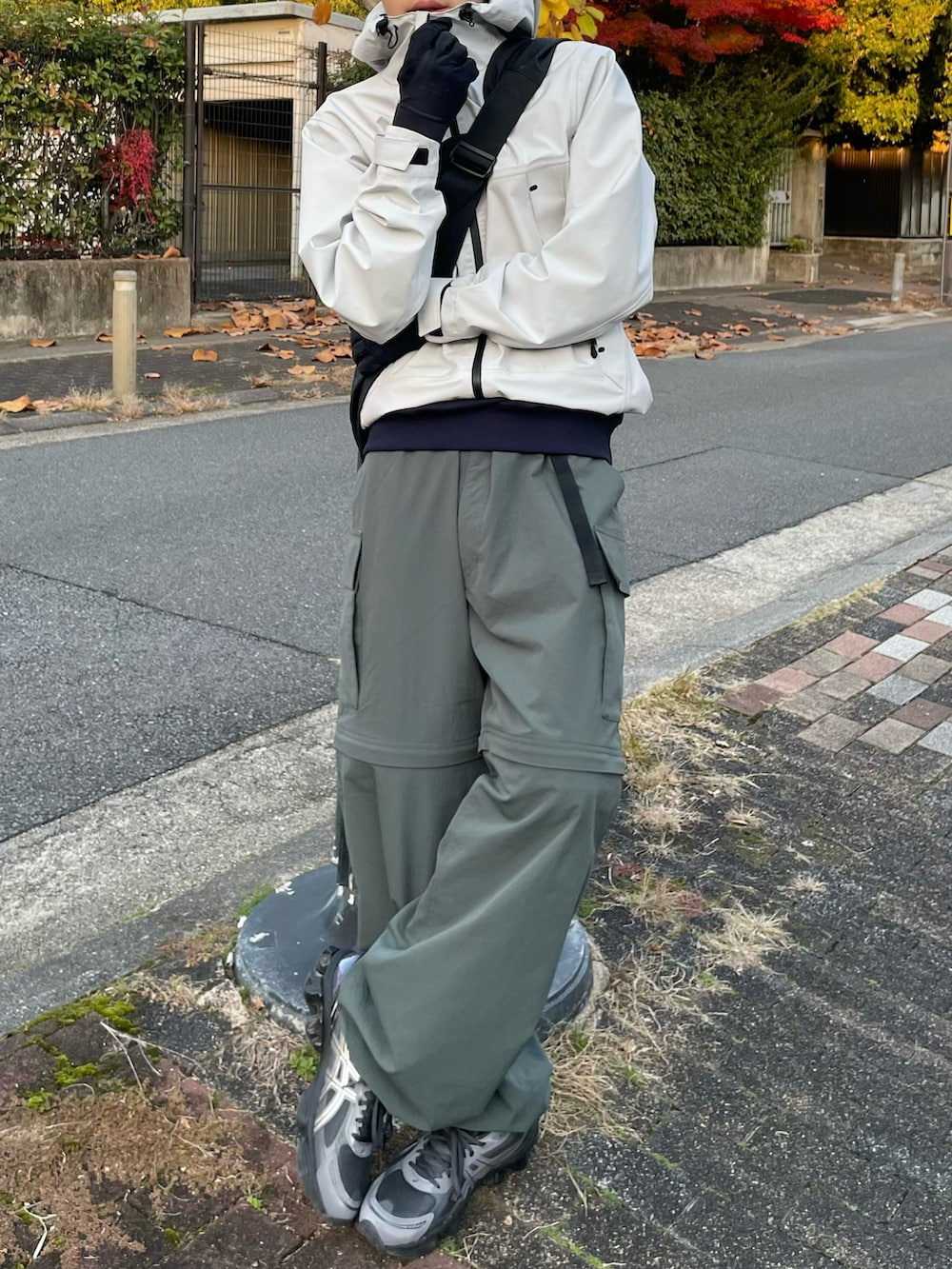 ブルー系のスウェット、ブラック系のショルダーバッグ、グレー系のスニーカーを着用したメンズの冬コーディネートの3枚目の写真