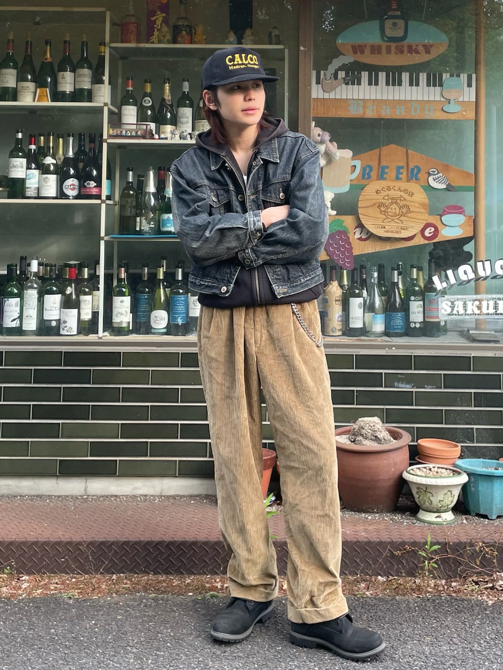 ブラック系のデニムジャケット、ブラック系のパーカー、ベージュ系のその他パンツを着用したメンズの春コーディネートの2枚目の写真