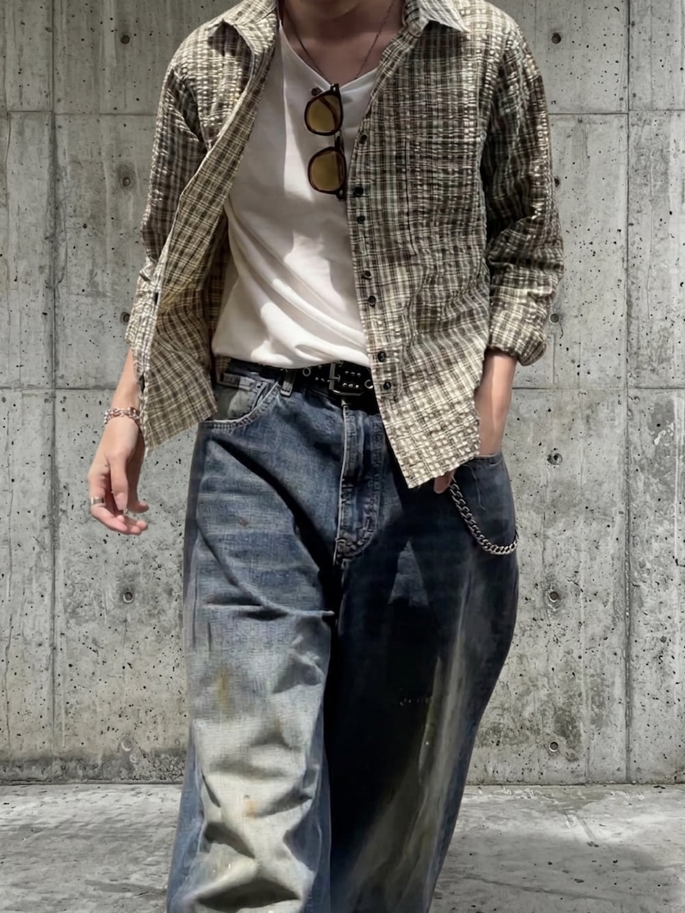 グリーン系のシャツ/ブラウス、ブラック系のドレスシューズ、ブルー系のデニムパンツを着用したメンズの春コーディネートの3枚目の写真