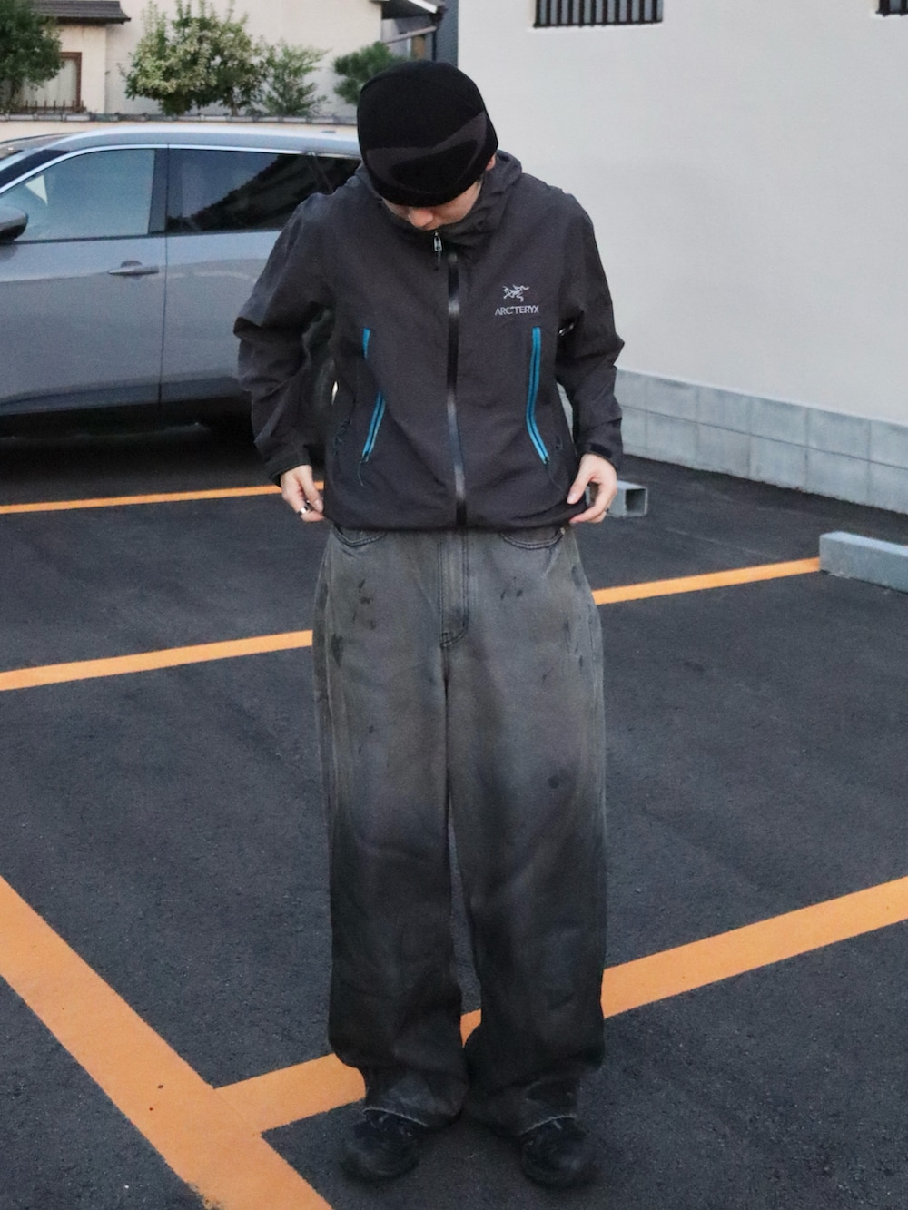 ブラック系のスニーカー、グレー系のマウンテンパーカー、その他のデニムパンツを着用したメンズの秋コーディネートの3枚目の写真