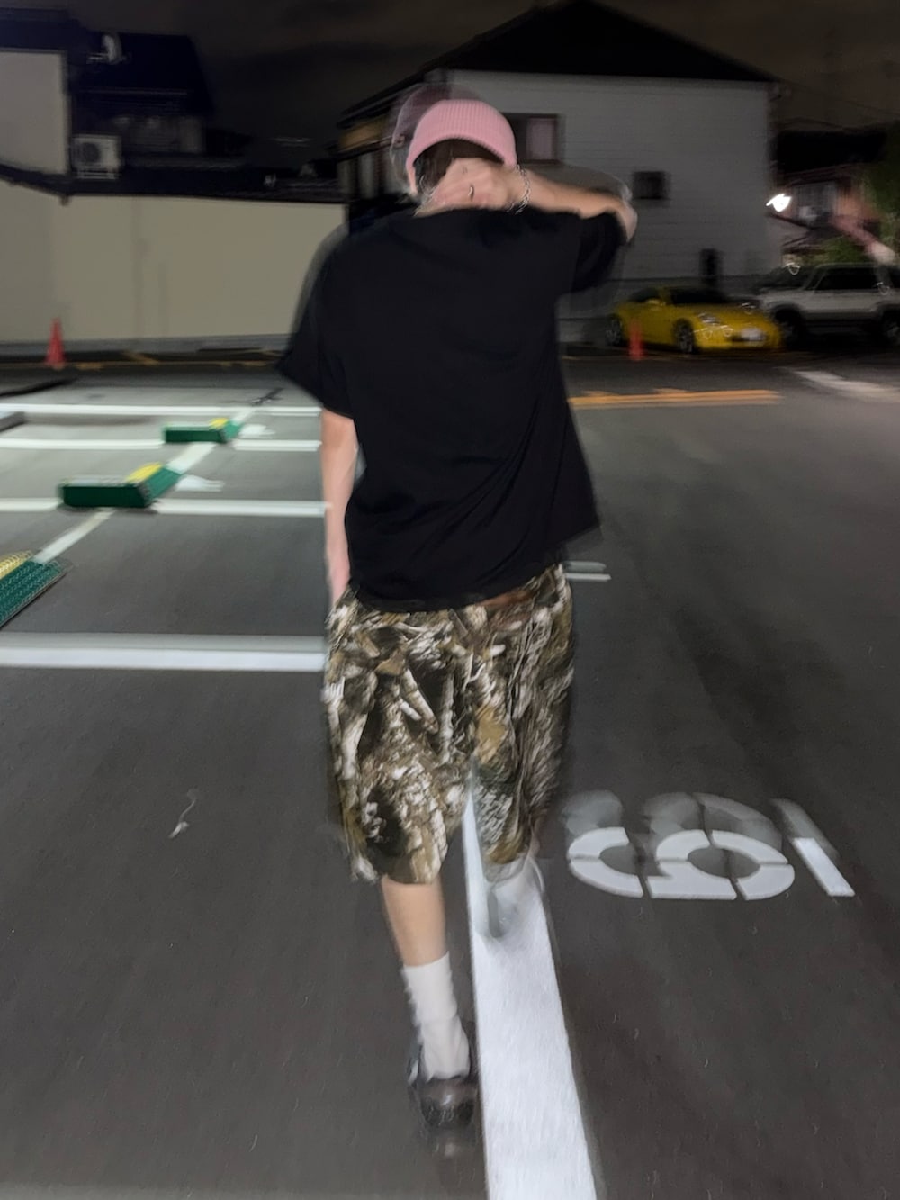 グレー系のスニーカー、ブラック系のTシャツ/カットソー、ベージュ系のパンツを着用したメンズの夏コーディネートの4枚目の写真