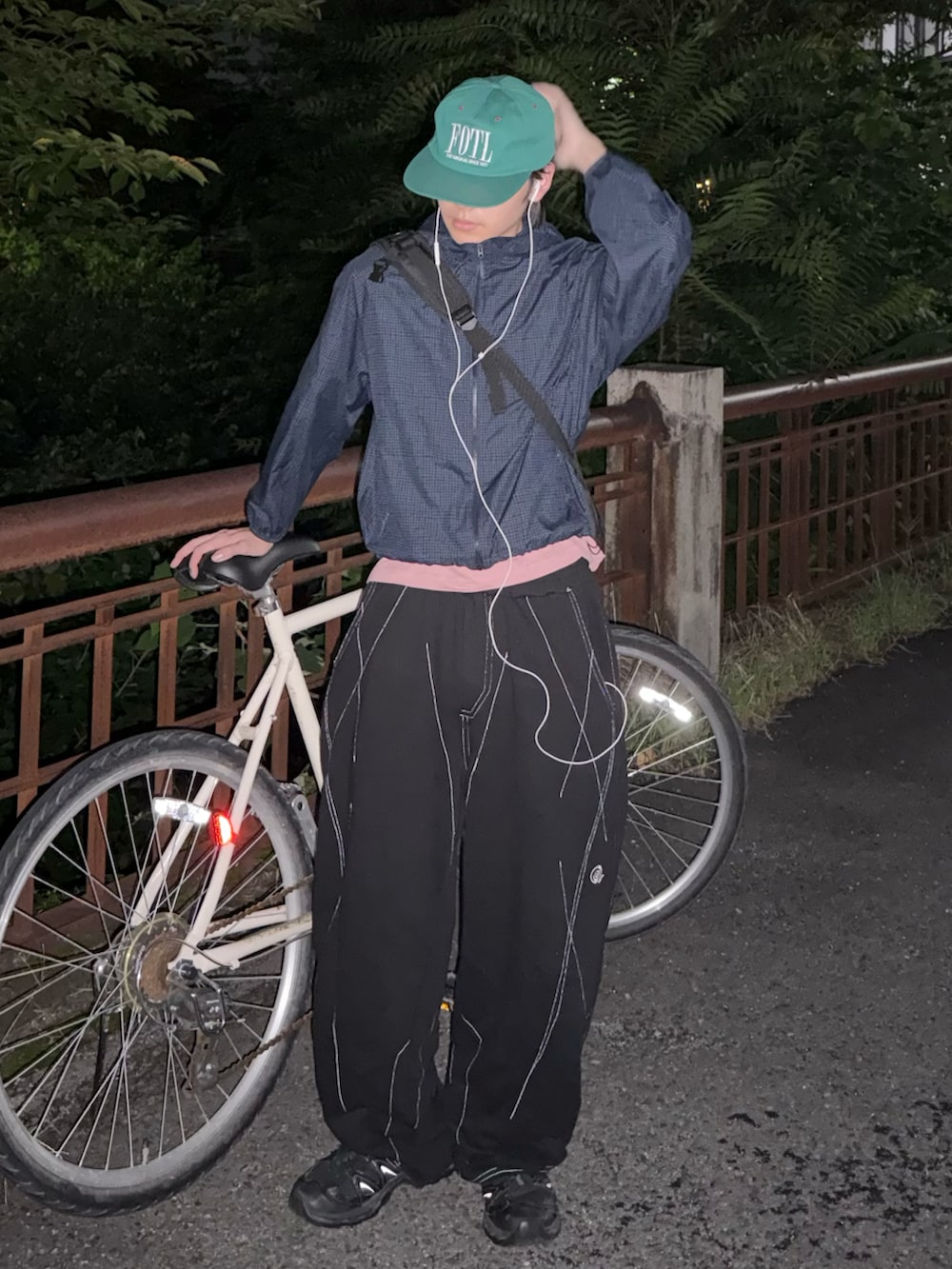 ブラック系のスニーカー、ブルー系のマウンテンパーカー、ブラック系のスウェットパンツを着用したメンズの夏コーディネートの2枚目の写真