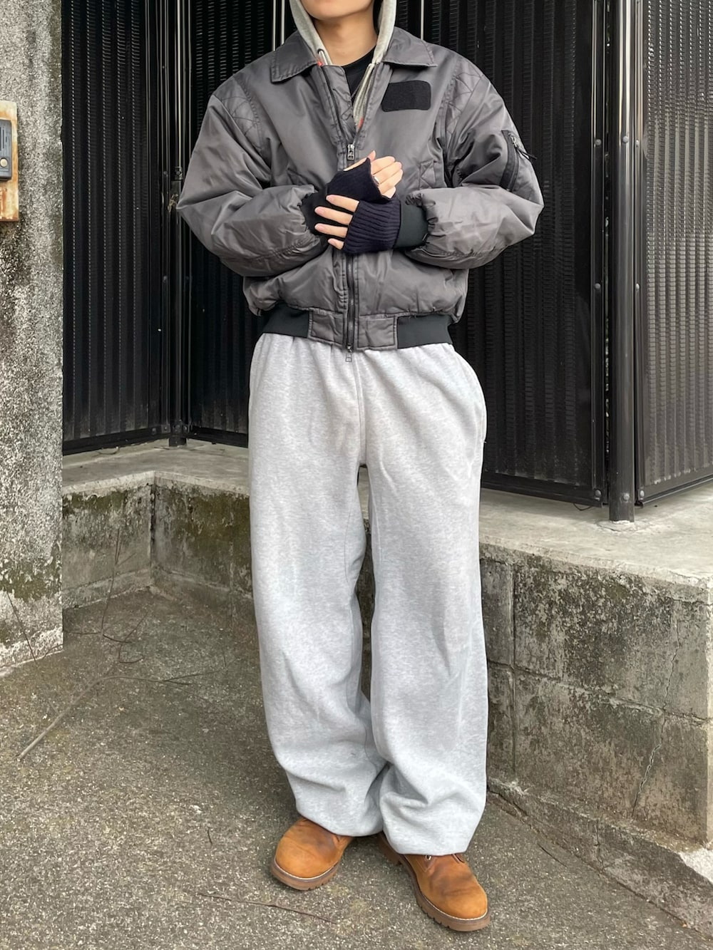 グレー系のパーカー、その他のMA-1、ブラウン系のブーツを着用したメンズの冬コーディネートの4枚目の写真