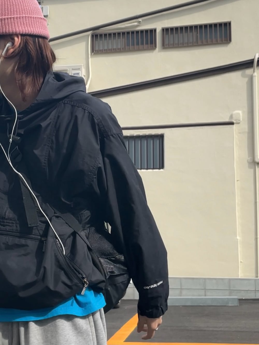 ブラック系のマウンテンパーカー、グレー系のスウェットパンツ、ブラック系のスニーカーを着用したメンズの春コーディネートの3枚目の写真