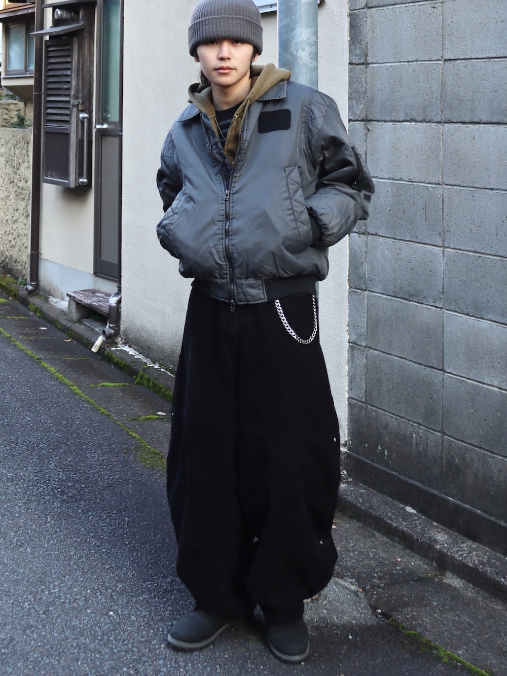 グリーン系のパーカー、ブラック系のブーツ、その他のMA-1を着用したメンズの冬コーディネートの4枚目の写真