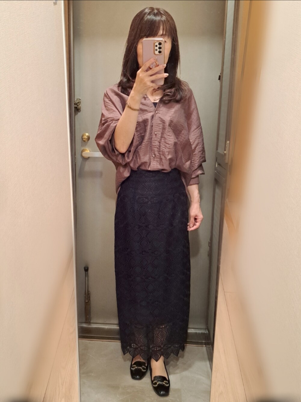 ブルー系のスカート、ブラウン系のシャツ/ブラウス、ベージュ系のパンプスを着用したレディースの秋コーディネートの2枚目の写真