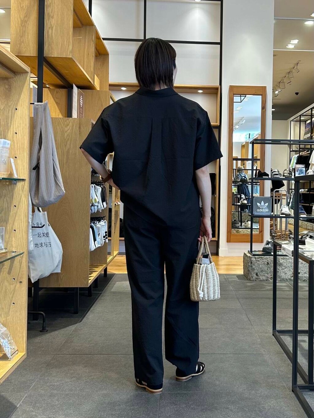 ブラック系のサンダル、グレー系のハンドバッグ、ホワイト系のTシャツ/カットソーを着用したレディースの夏コーディネートの3枚目の写真