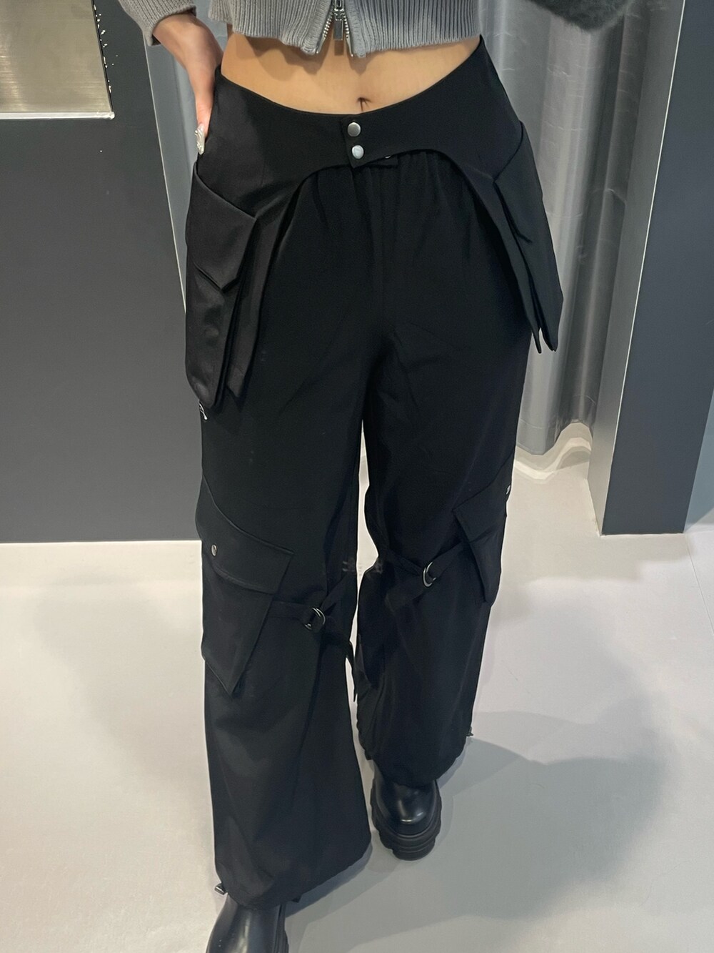 グレー系のニット/セーター、ブラック系のその他パンツ、ブラック系のブーツを着用したレディースの冬コーディネートの6枚目の写真