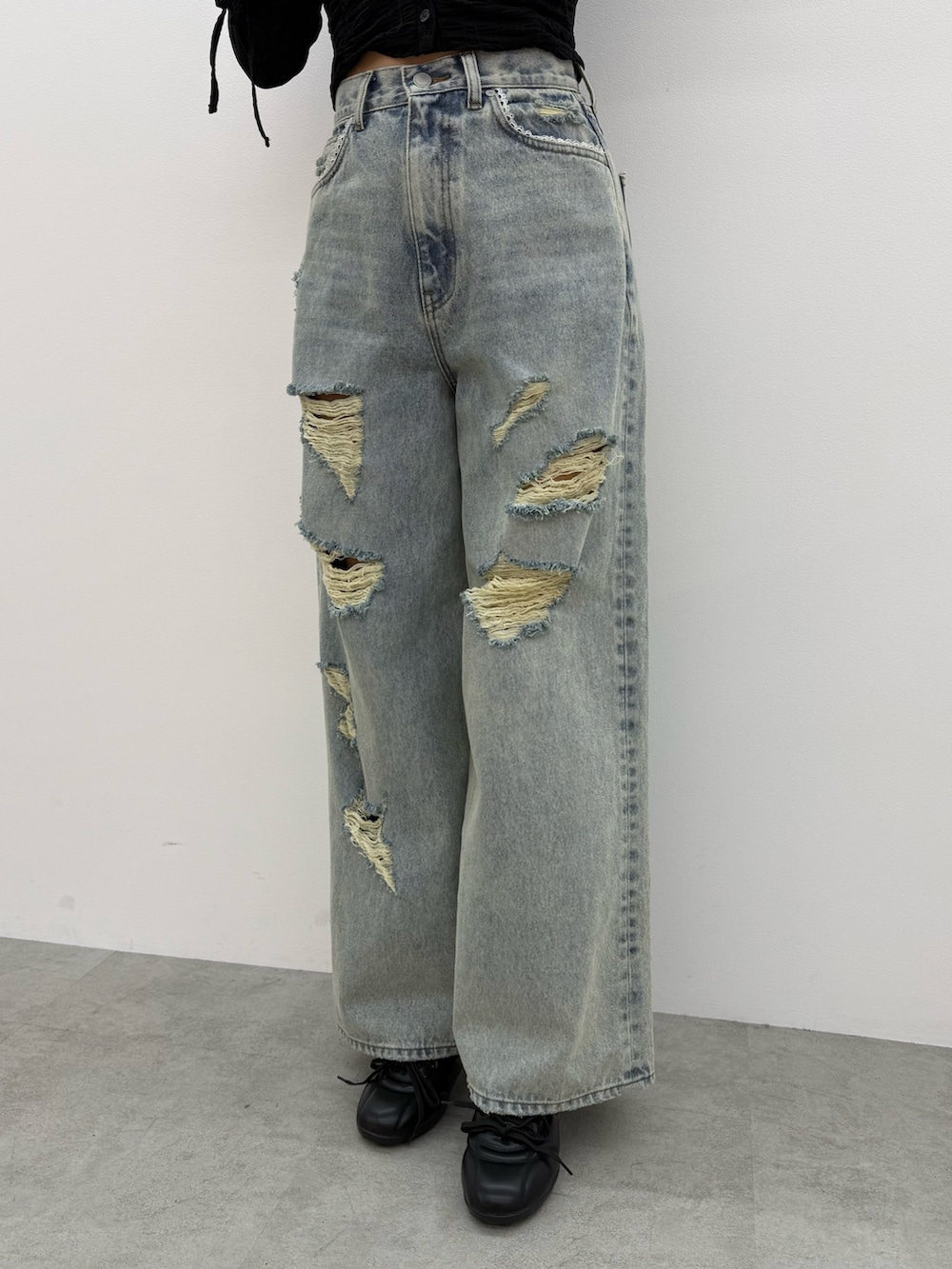 ピンク系のニット/セーター、ブルー系のデニムパンツ、ブラック系のスニーカーを着用したレディースの冬コーディネートの5枚目の写真