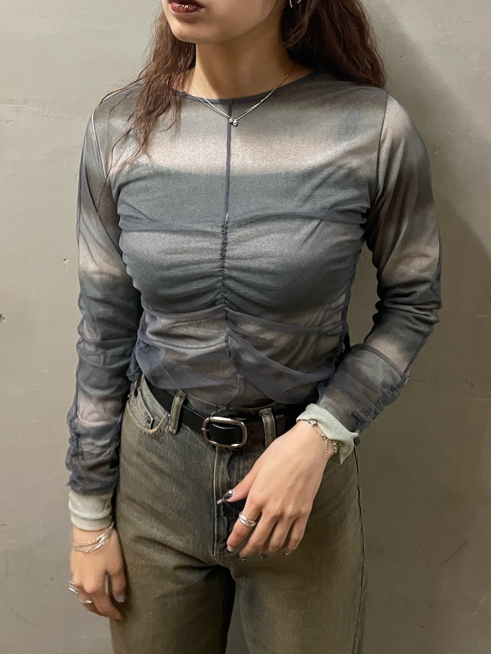 グレー系のTシャツ/カットソー、ブルー系のデニムパンツ、ブラック系のブーツを着用したレディースの春コーディネートの4枚目の写真