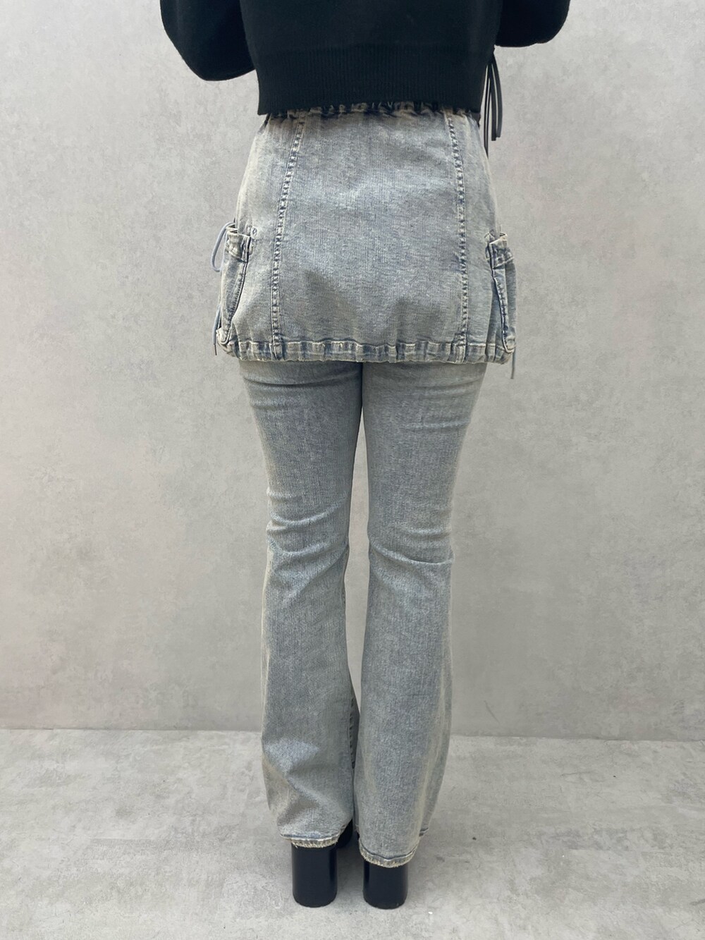 ホワイト系のニット/セーター、ブルー系のデニムパンツ、ブラック系のローファーを着用したレディースの夏コーディネートの8枚目の写真