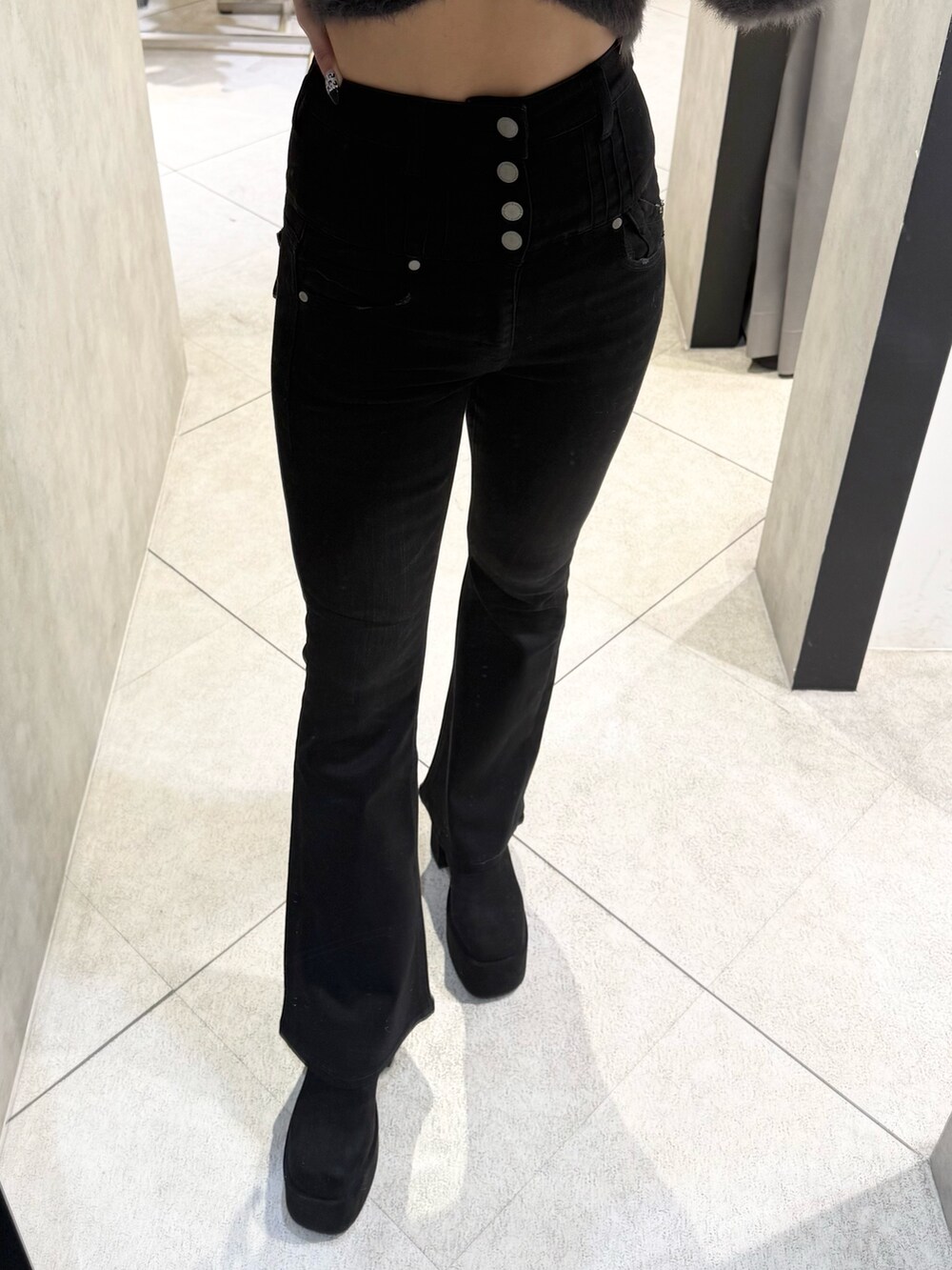 ブラウン系のニット/セーター、ブラック系のデニムパンツ、ブラック系のブーツを着用したレディースの秋コーディネートの6枚目の写真