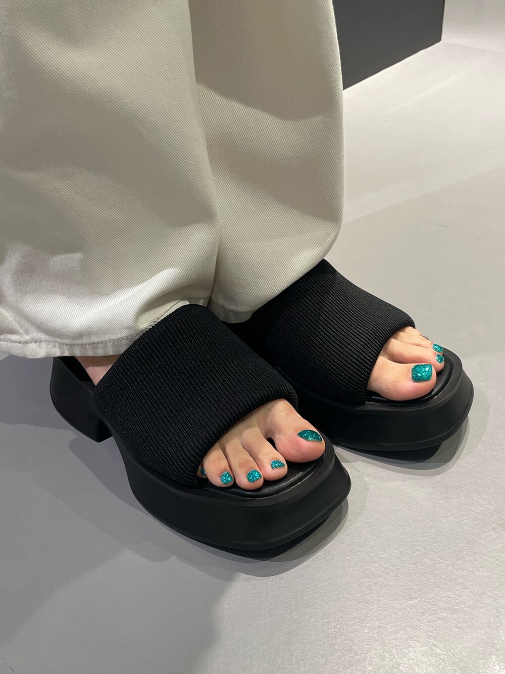 グレー系のTシャツ/カットソー、ブルー系のデニムパンツ、ホワイト系のサンダルを着用したレディースの夏コーディネートの9枚目の写真