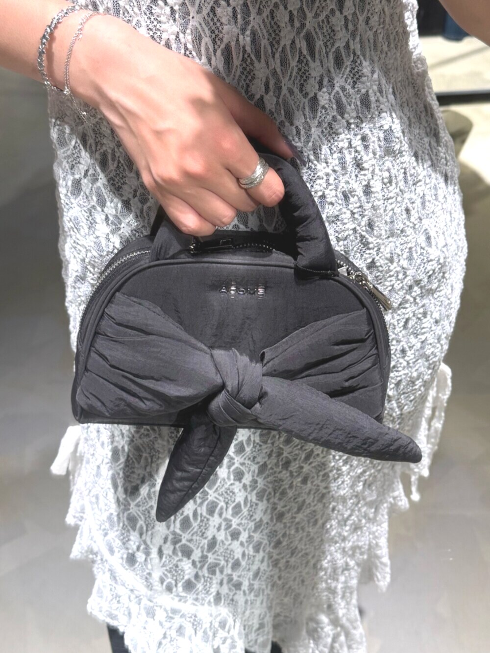 ブラック系のデニムパンツ、ブラック系のニット/セーター、ブラック系のサンダルを着用したレディースの夏コーディネートの8枚目の写真