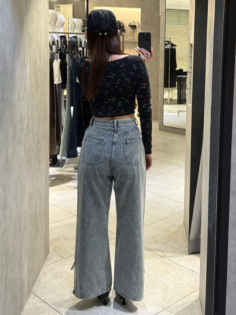 ブラック系のTシャツ/カットソー、ブルー系のデニムパンツ、ブラック系のスニーカーを着用したレディースの春コーディネートの3枚目の写真