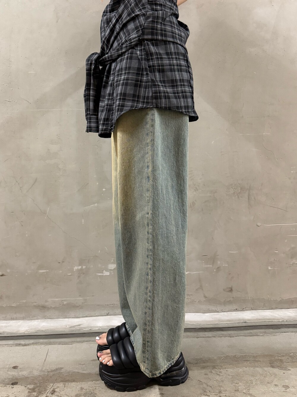 グレー系のワンピース、ブルー系のデニムパンツ、ブラック系のサンダルを着用したレディースの夏コーディネートの8枚目の写真