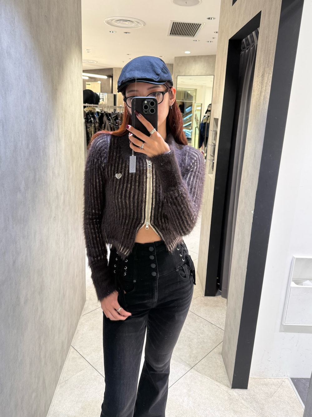 ブラウン系のニット/セーター、ブラック系のデニムパンツ、ブラック系のブーツを着用したレディースの秋コーディネートの4枚目の写真