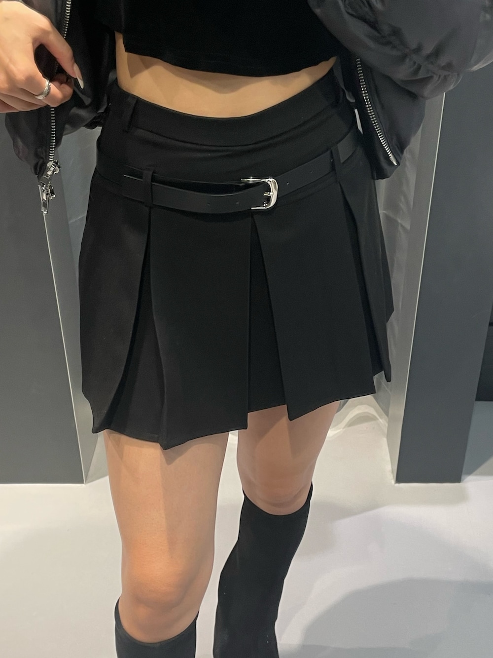 グレー系のニット/セーター、ブラック系のスカート、ブラック系のハンドバッグを着用したレディースの冬コーディネートの6枚目の写真