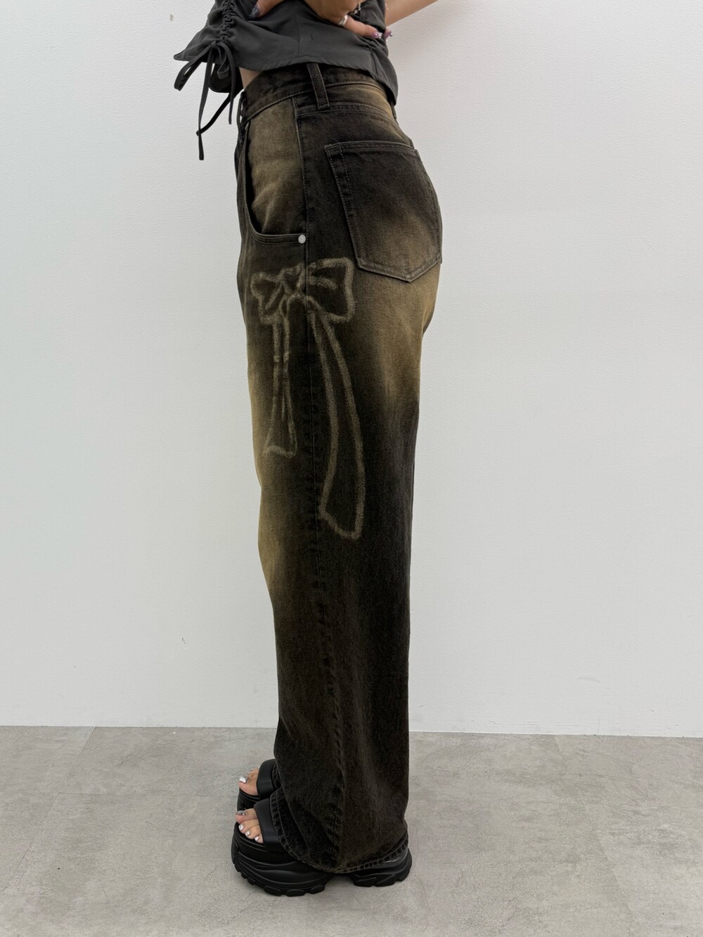 ブラック系のデニムパンツ、ブラック系のサンダル、シルバー系のネックレスを着用したレディースの夏コーディネートの8枚目の写真