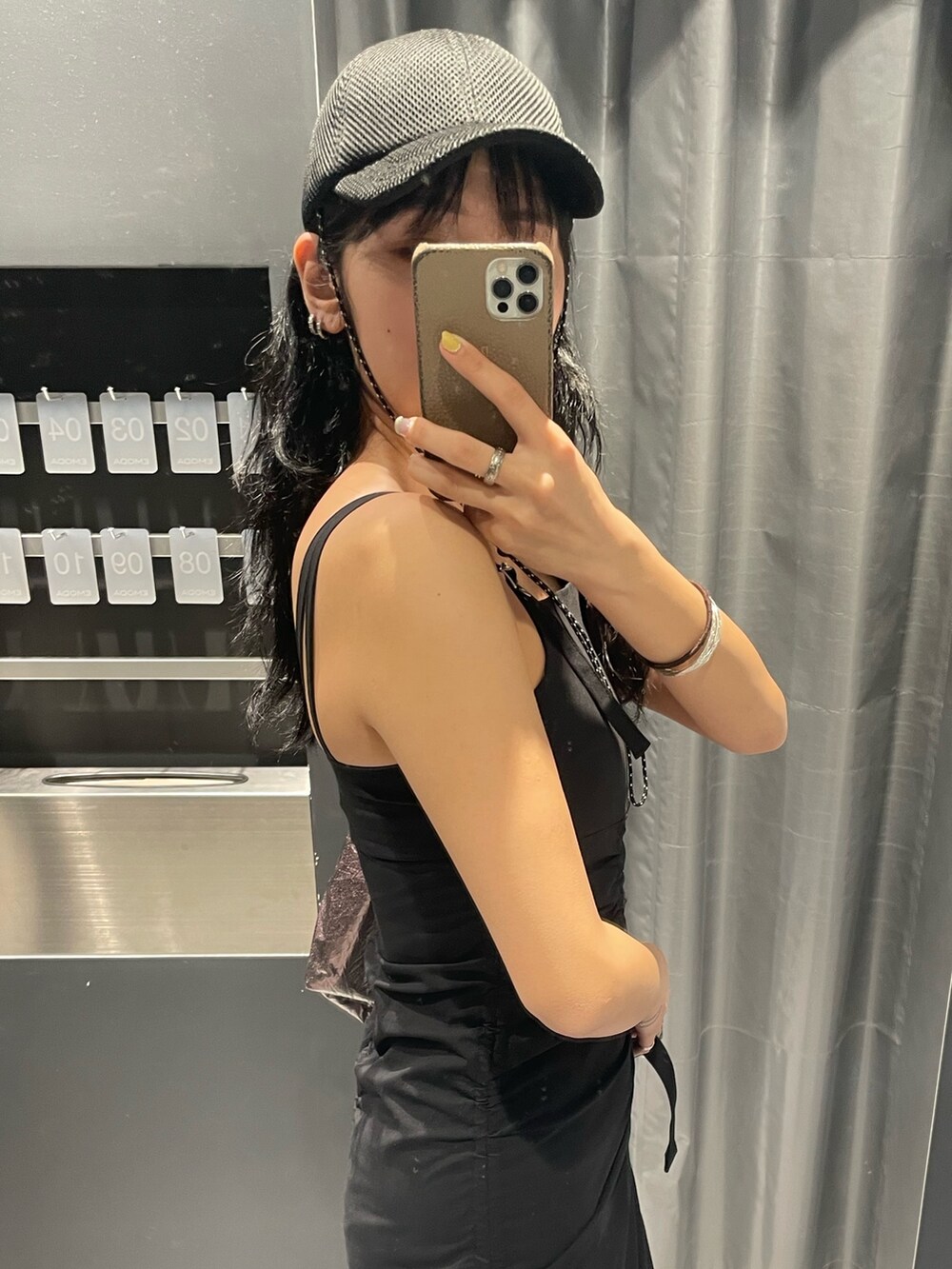 ブラック系のワンピース、グレー系のハンドバッグ、ブラック系のサンダルを着用したレディースの春コーディネートの5枚目の写真