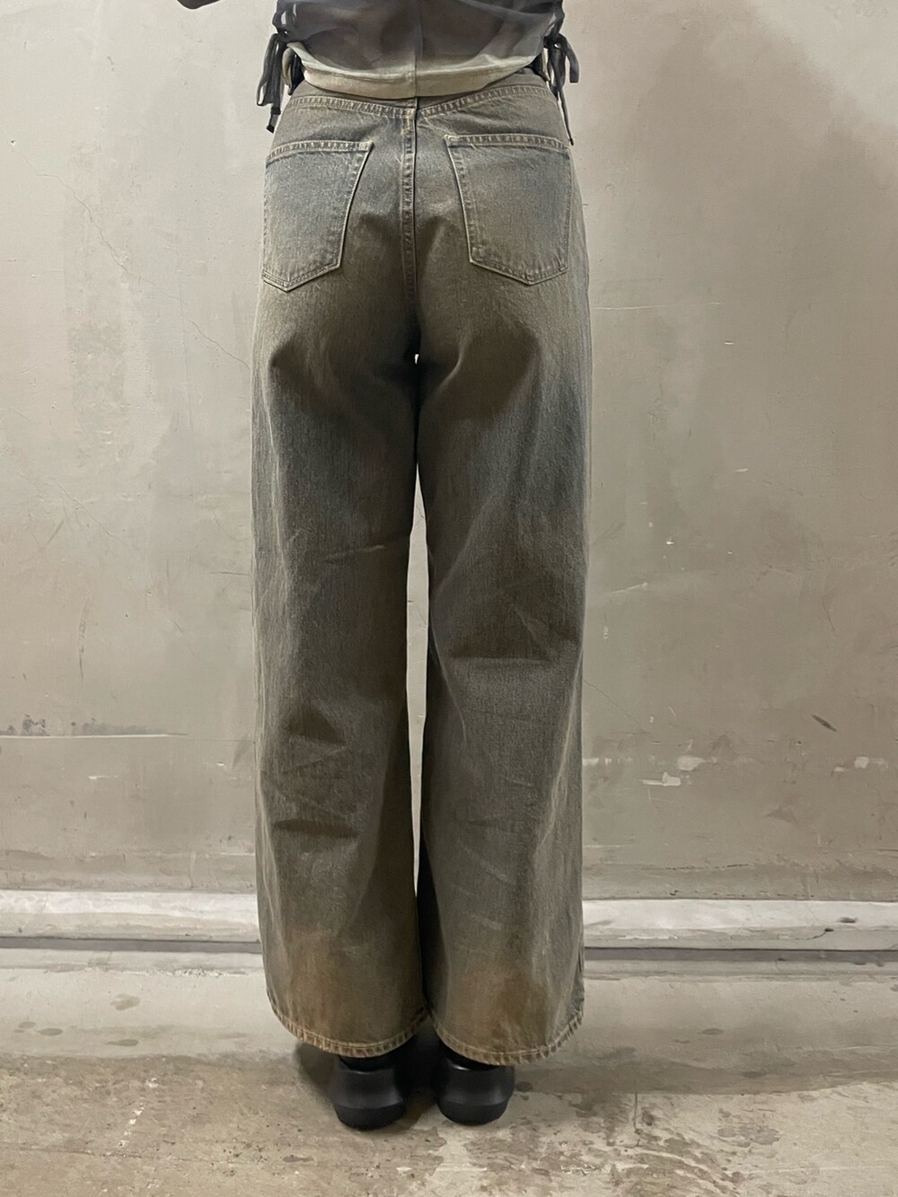 グレー系のTシャツ/カットソー、ブルー系のデニムパンツ、ブラック系のブーツを着用したレディースの春コーディネートの9枚目の写真