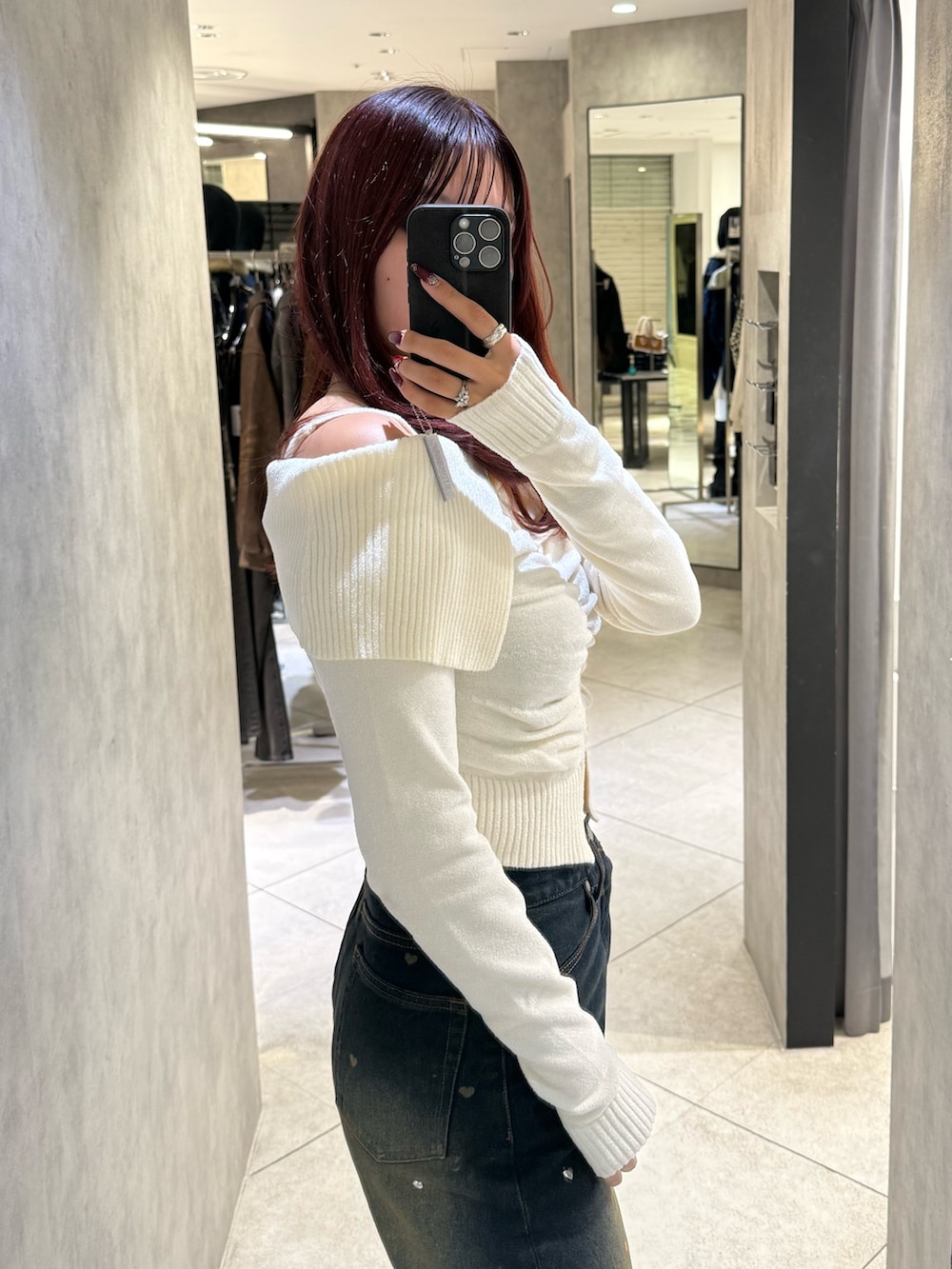 ホワイト系のニット/セーター、ブルー系のデニムパンツ、ブラック系のブーツを着用したレディースの秋コーディネートの5枚目の写真