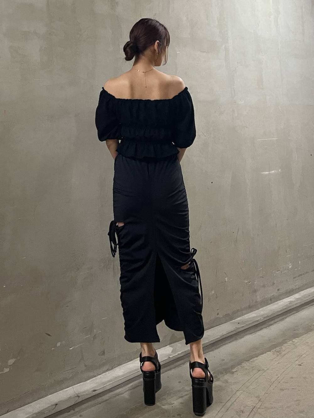 ブラック系のTシャツ/カットソー、ブラック系のスカート、ブラック系のサンダルを着用したレディースの春コーディネートの3枚目の写真