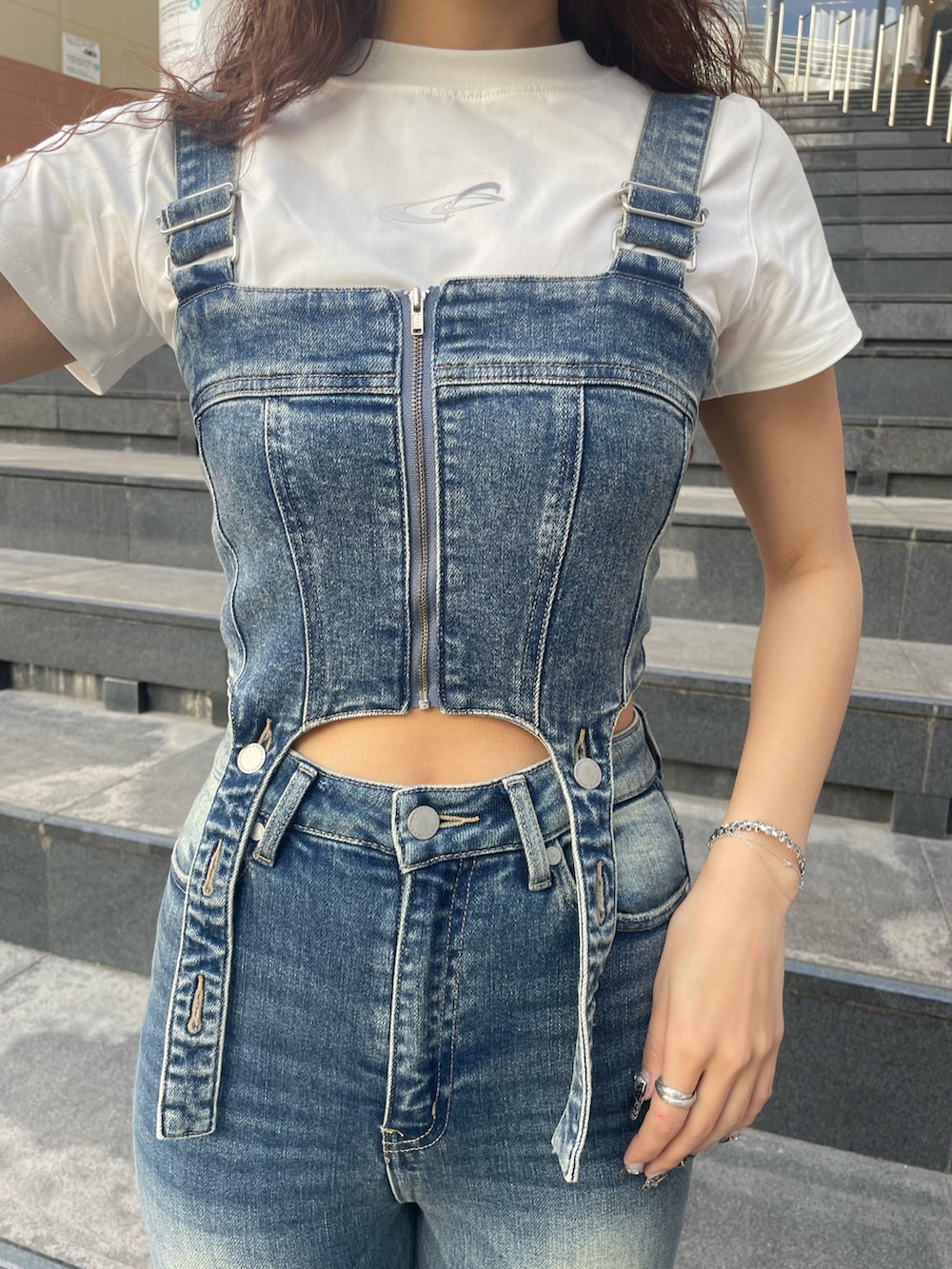 ホワイト系のTシャツ/カットソー、ブルー系のサロペット/オーバーオール、ブラック系のハンドバッグを着用したレディースの春コーディネートの4枚目の写真