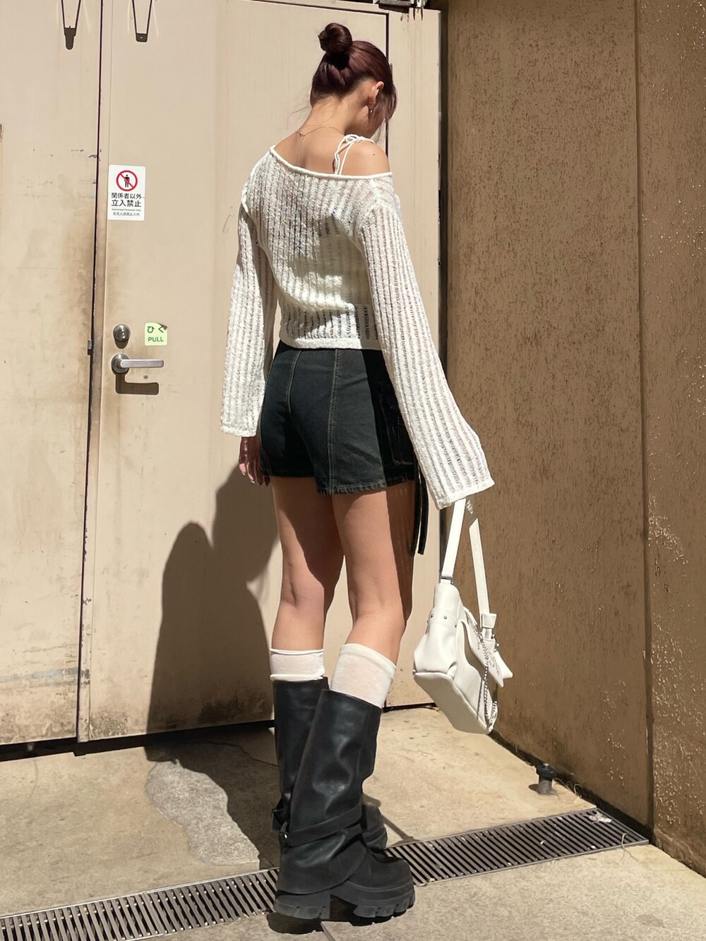 ホワイト系のニット/セーター、ブルー系のその他パンツ、ホワイト系のハンドバッグを着用したレディースの春コーディネートの3枚目の写真