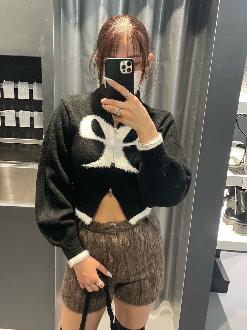 ブラック系のニット/セーター、ブラウン系のその他パンツ、ブラック系のショルダーバッグを着用したレディースの冬コーディネートの4枚目の写真