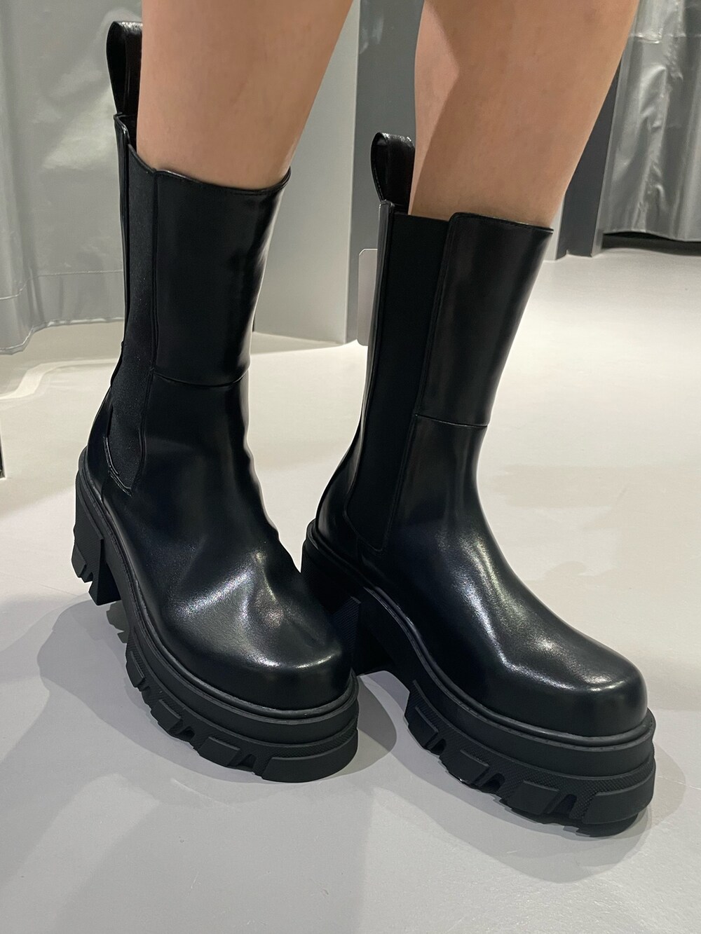 ブラック系のTシャツ/カットソー、ブルー系のデニムパンツ、ブラック系のブーツを着用したレディースの春コーディネートの8枚目の写真