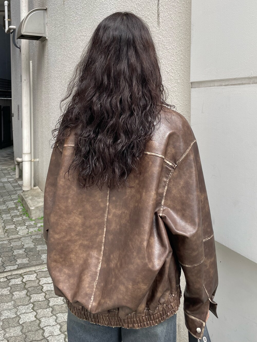 ホワイト系のシャツ/ブラウス、ブラウン系のブルゾン、ブルー系のデニムパンツを着用したレディースの秋コーディネートの6枚目の写真