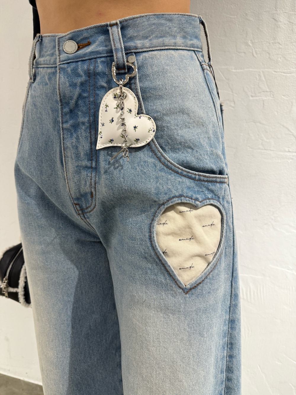 ホワイト系のニット/セーター、ブルー系のデニムパンツ、ブラック系のハンドバッグを着用したレディースの秋コーディネートの6枚目の写真