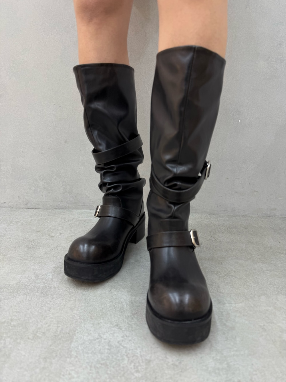 ブラック系のTシャツ/カットソー、ブラック系のスカート、ブラック系のブーツを着用したレディースの冬コーディネートの7枚目の写真