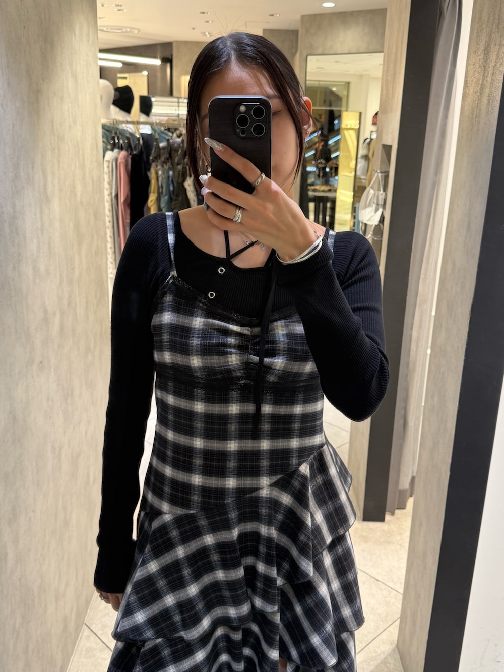 ブラック系のニット/セーター、ブラック系のワンピース、ブラック系のブーツを着用したレディースの春コーディネートの4枚目の写真