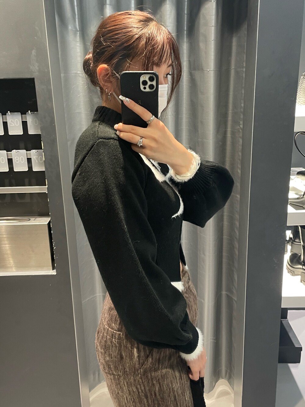 ブラック系のニット/セーター、ブラウン系のその他パンツ、ブラック系のショルダーバッグを着用したレディースの冬コーディネートの5枚目の写真