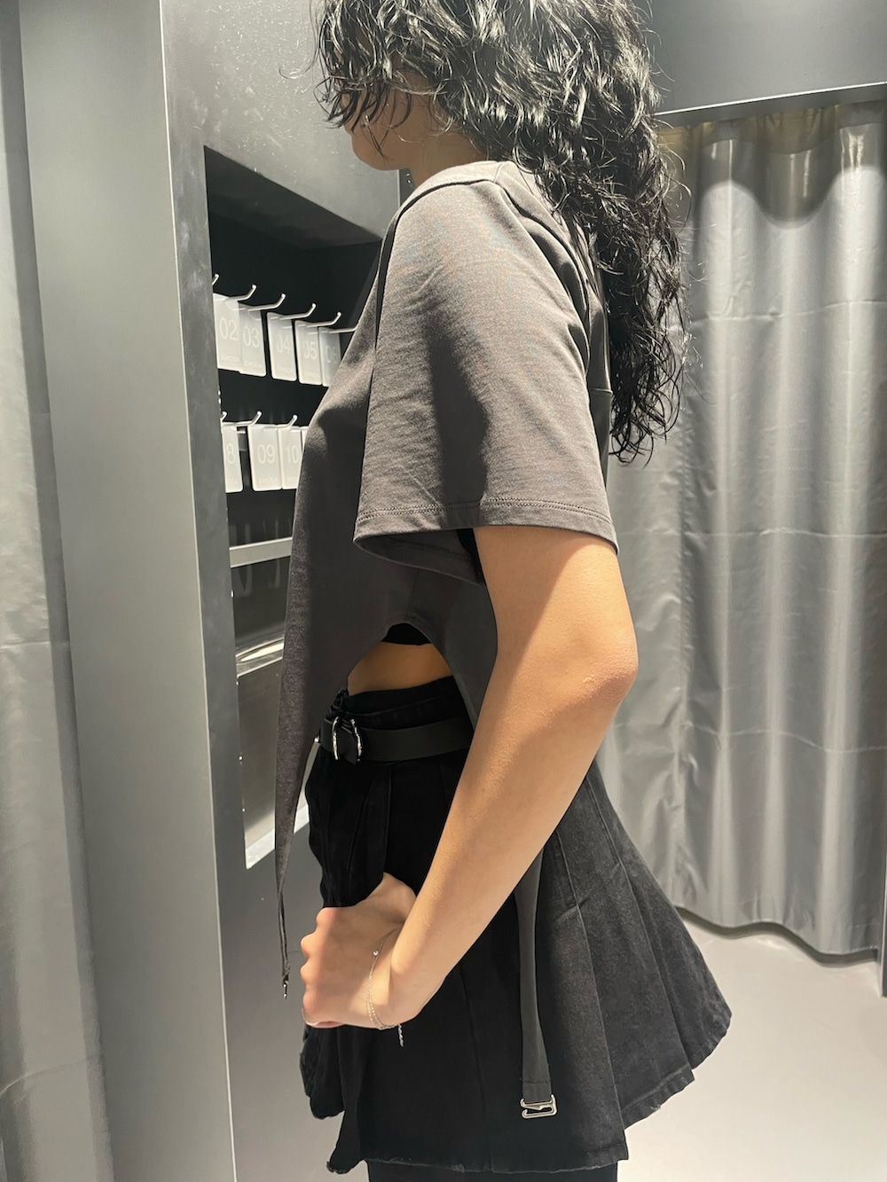 グレー系のTシャツ/カットソー、ブラック系のデニムスカート、ブラック系のデニムパンツを着用したレディースの春コーディネートの5枚目の写真