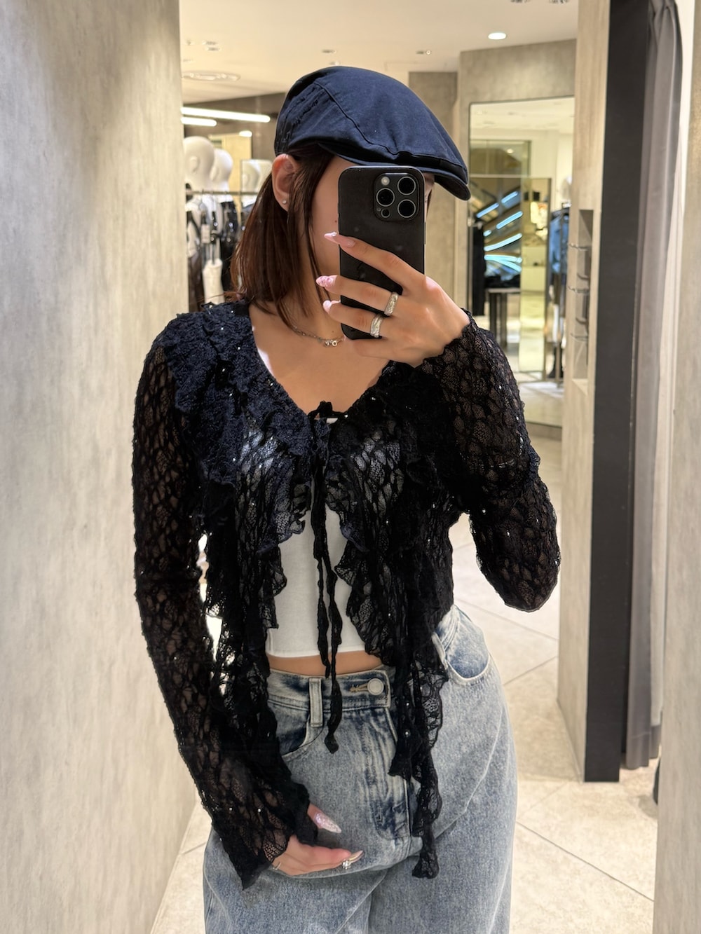 ブラック系のTシャツ/カットソー、ホワイト系のニット/セーター、ブルー系のデニムパンツを着用したレディースの春コーディネートの4枚目の写真