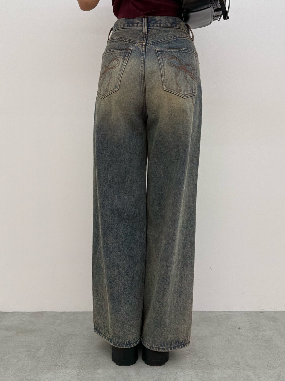 ブラック系のTシャツ/カットソー、ブルー系のデニムパンツ、ブラック系のブーツを着用したレディースの夏コーディネートの6枚目の写真